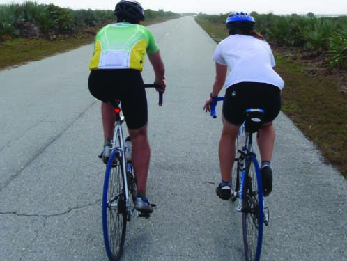 Jennifer (right) and husband John (left) ride their bikes while training in Florida. Photo courtesy of Jennifer Meyer.