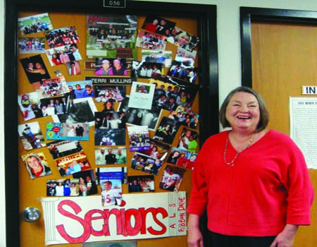 Mullins shows off her office door, decorated with various pictures of students. Photo by Meaghan Flynn.