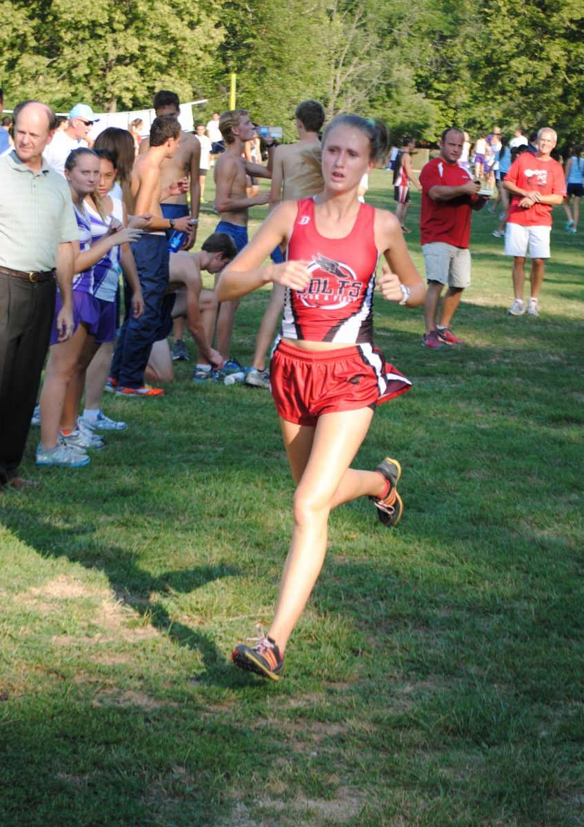 Senior Kayla Friesen sprints to the finish during the Parkway Quad at Castlewood State Park on Aug. 30. Photo by Tara Stepanek.