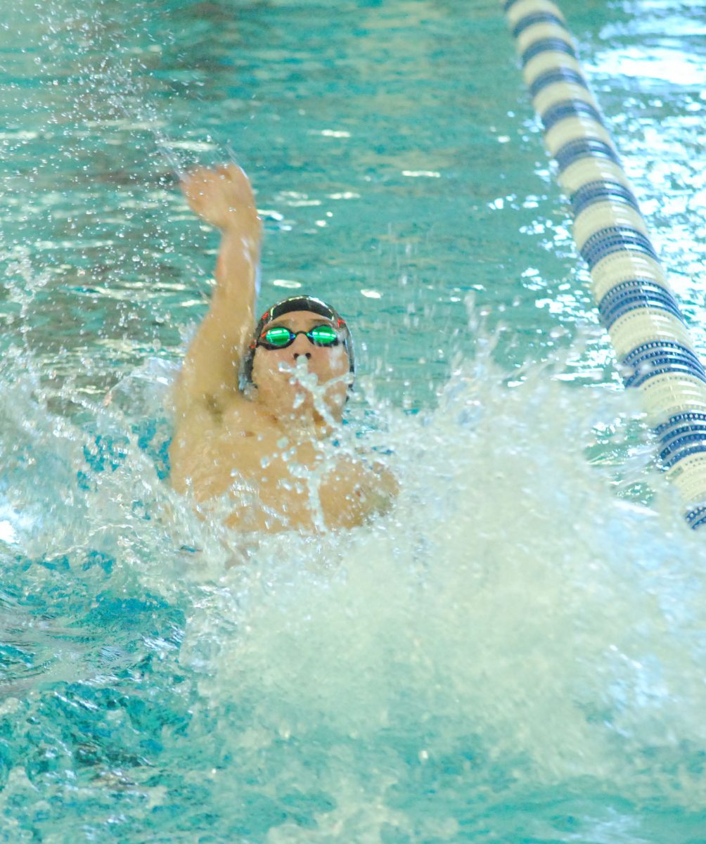 Junior Riley Brown swims the backstroke at the Marquette Relays on Sept. 8.