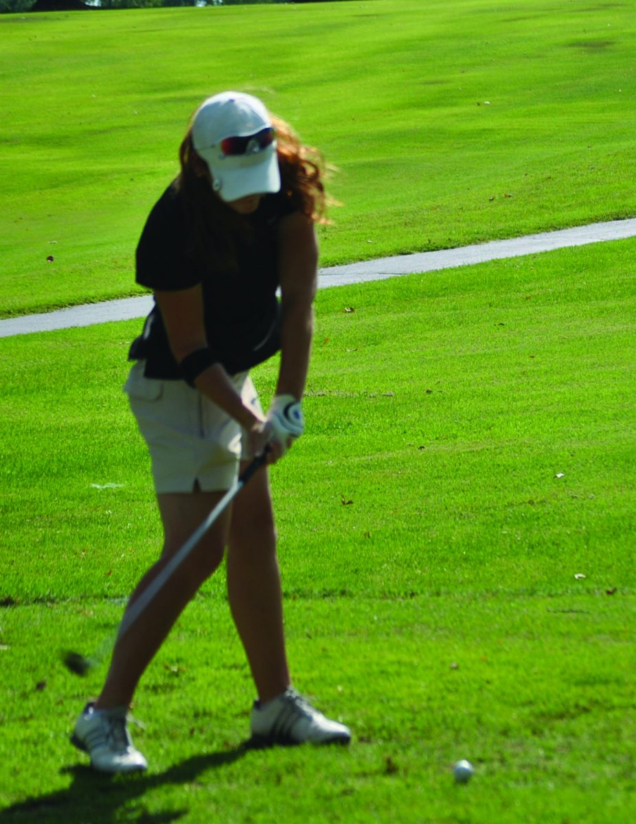 Sophomore Elizabeth Leath prepares to hit the ball from the fairway. “This year I would be really pleased to finish in the top 15 at state,” Leath said. Photo by Catherine Melvin.