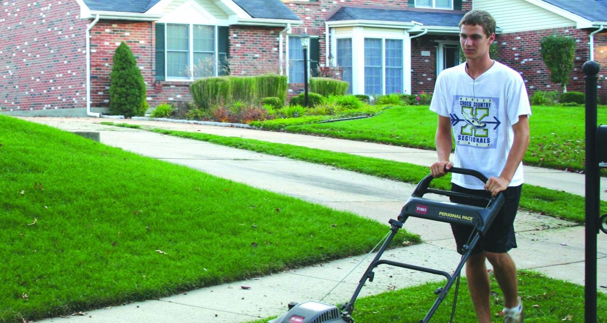 Krumrey mows the lawn for his next door neighbor. His main clients are his neighbors, creating an easy walk to work. Photo by Brandon Weissman.