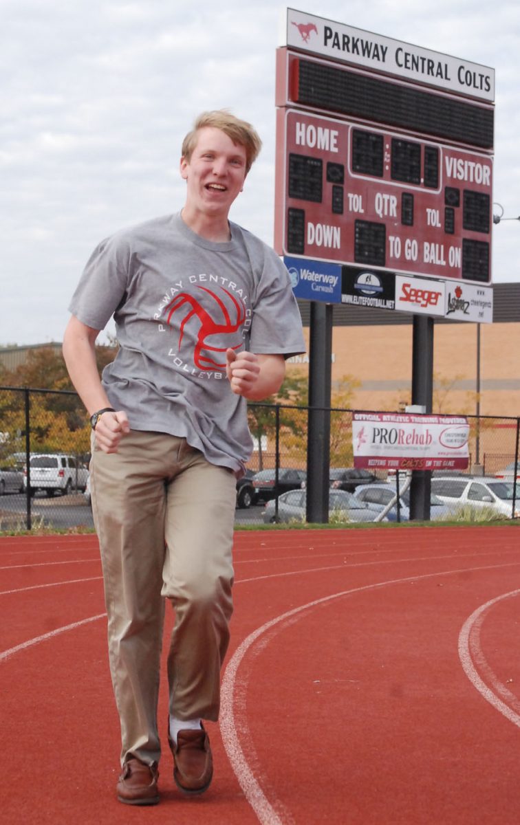 Miller smiles as he walks the track. In early October, Miller broke the school record for a walked mile when he clocked in at 8:32.