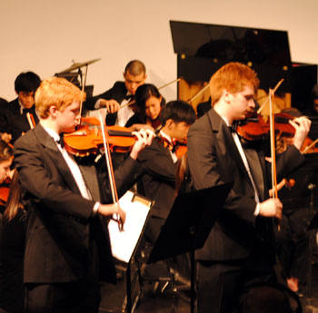 Seniors Adam McDonald and Sean Byrne perform a duet during the Symphonic Strings Orchestra performance. Photo by Meaghan Flynn. 