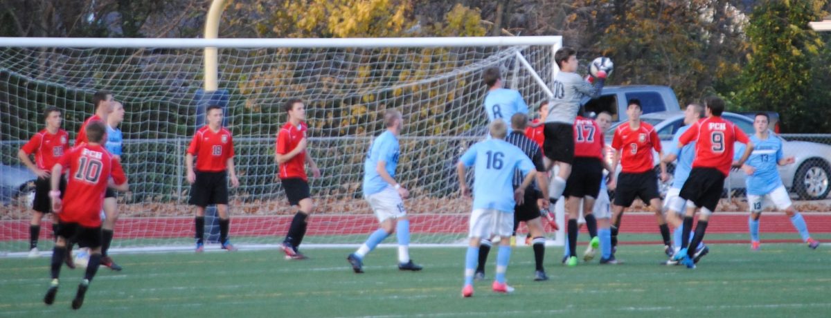 Senior Andrew Chekadanov saves a shot during the quarterfinal game at St. Dominic on Nov. 10.  Photo by Ms. Stepanek 