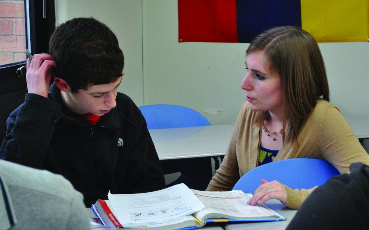 Ms. Christy Keating helps freshman Noah Grossman with a worksheet. Photo by Emily Schenberg.