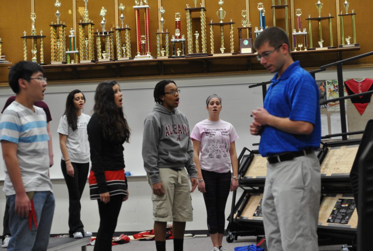 Choir teacher Mr. Ben Silvermintz conducts the Pizzaz for their upcoming competition on Jan. 12. 