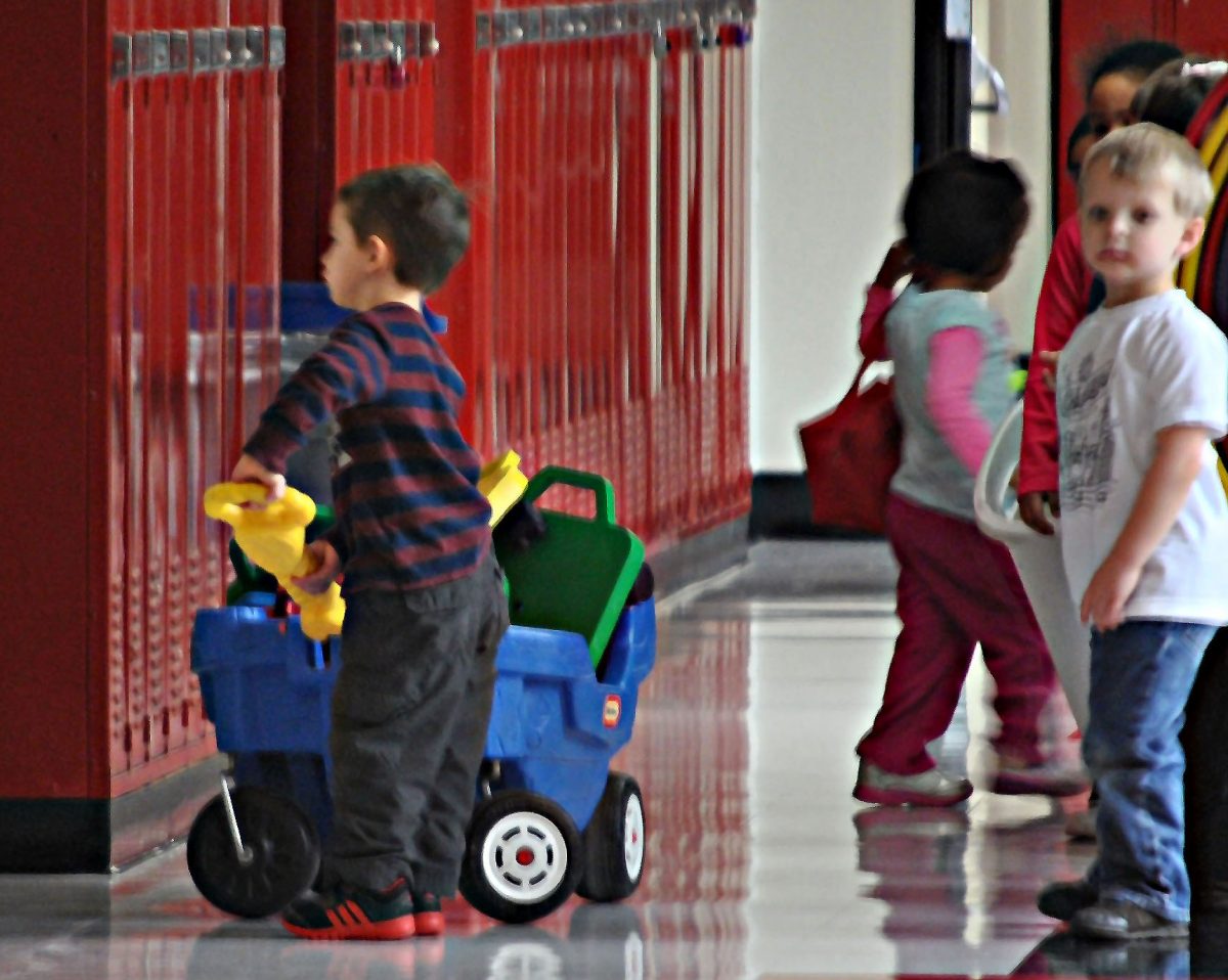 A+preschooler+pushes+a+toy+cart+as+he+and+his+classmates+head+back+to+class.+Photo+by%3A+Zach+Prelutsky