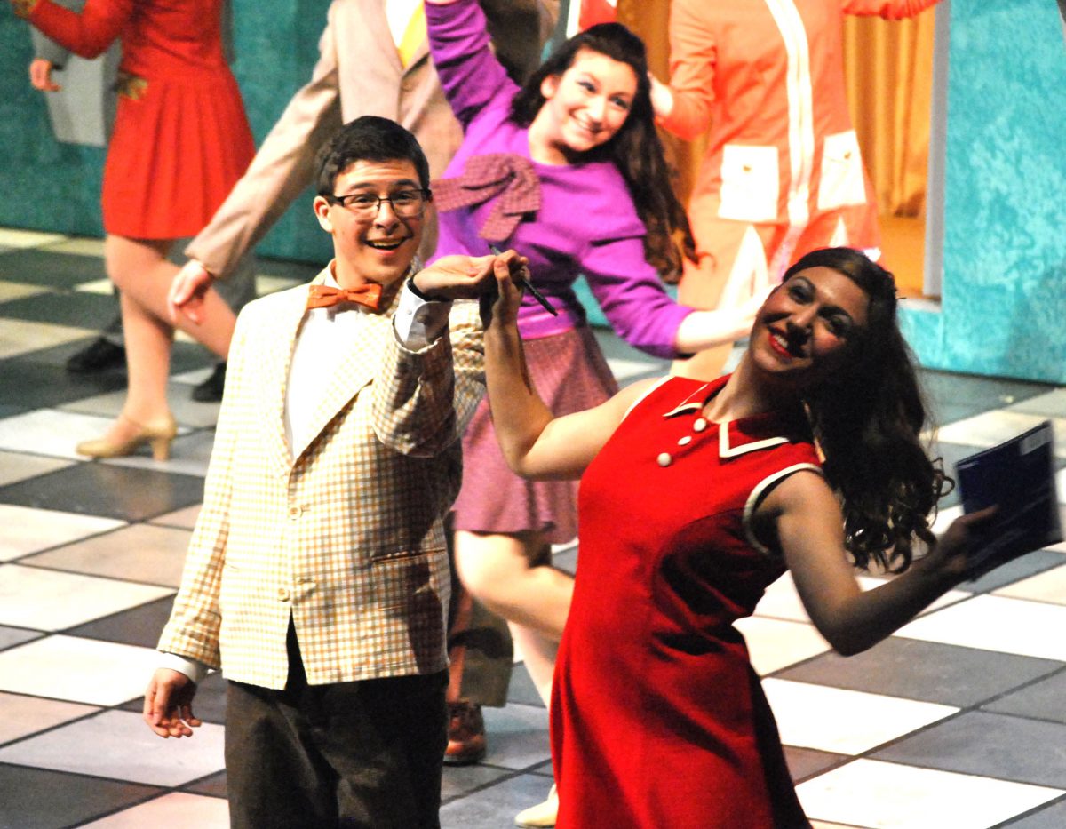 Junior Jake Blonstein and junior Greta Rosenstock dance and sing during their teaser for the spring musical How To Succeed In Business Without Really Trying. Photo by Dean Trail. 
