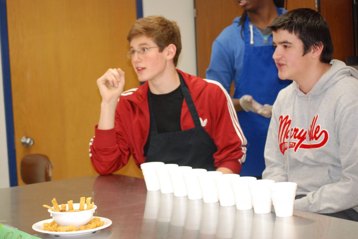 Max Schechter and Jason Jones pitch their chili in the chili cook-off. The participants included six cooking groups, while the judges were made up of Central staff and administrators. Photo by Matt Frischer.