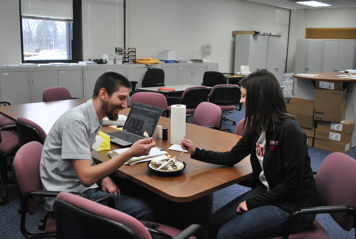 Math+teachers+Mr.+Nathan+Wilson+and+Ms.+Sarah+Reeves+enjoy+a+pie+in+the+math+office+in+celebration+of+national+pi+day.