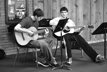 Juniors Sam Winter and Matthew Bernstein play guitar in the theater lobby during their Guitar 2 class. Photo by Meaghan Flynn.