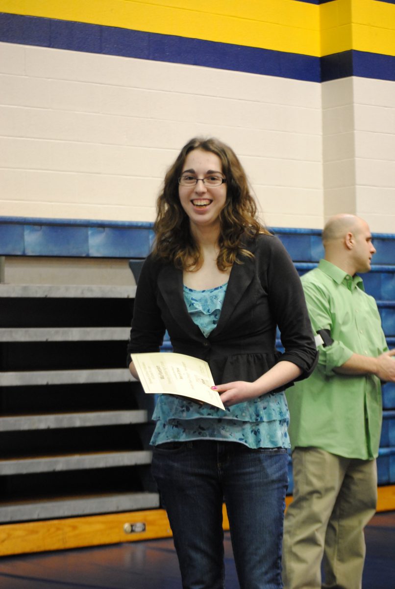 Senior Mia Kweskin recieves the award for best in show for inside page design at the 2013 SSP Spring Publications Conference at Webster University. Photo by Tara Stepanek.