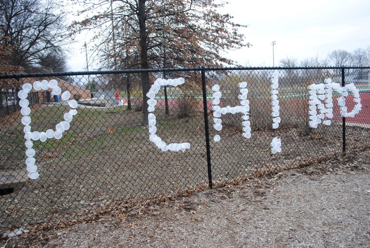 PCH! Bro is spelled out in clear plastic cups in the fence adjacent to the football field. Photo by Austin Dubinsky.