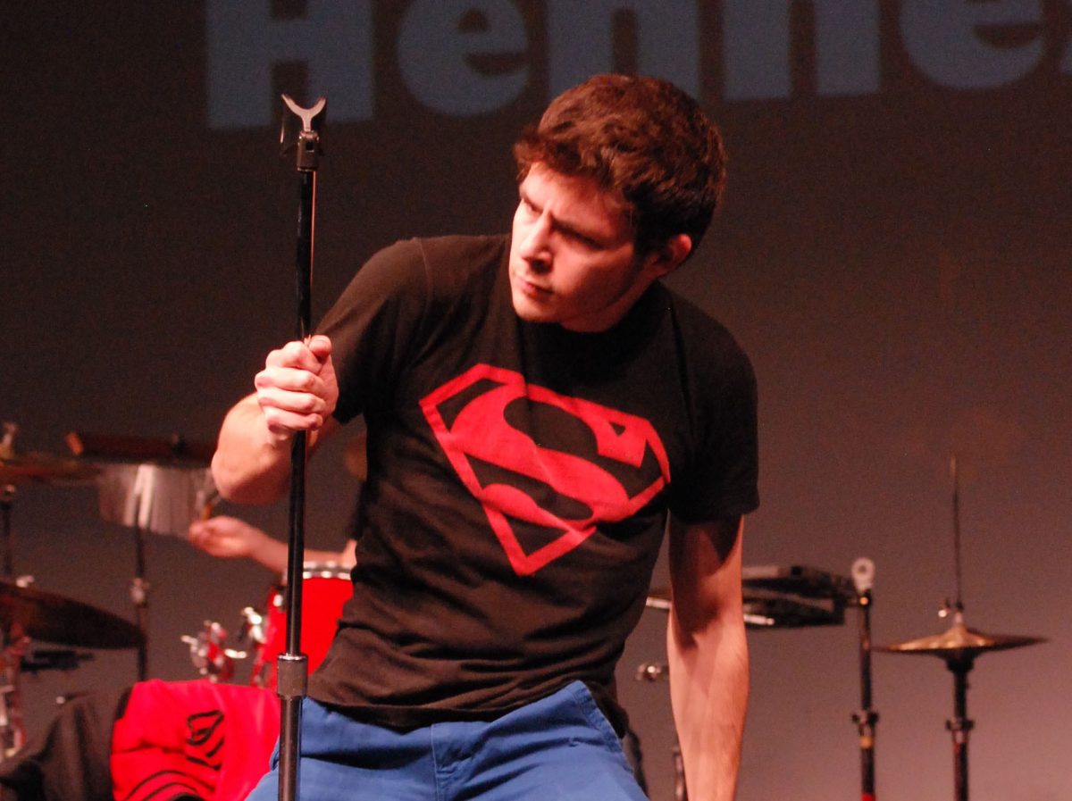 Junior Jake Blonstein gets into his performance by dramatically grabbing the microphone. Photo by Emily Schenberg.