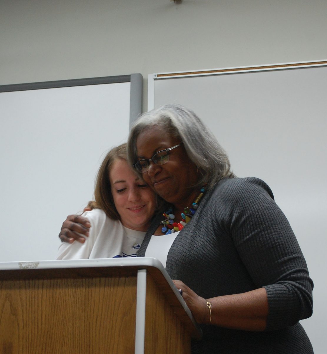 Sharon Robinson embraces freshman Jennifer Wayland after she read her essay to Cindy Krones English I Class. Photo by Austin Dubinsky.