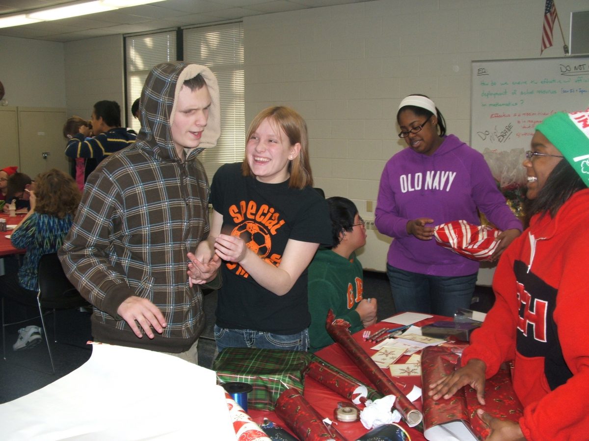 Senior Madison Edwards  and freshman Trenton Taylor wrap presents at the 2012 Holiday Party. Photo courtesy of Laura Lukowski.