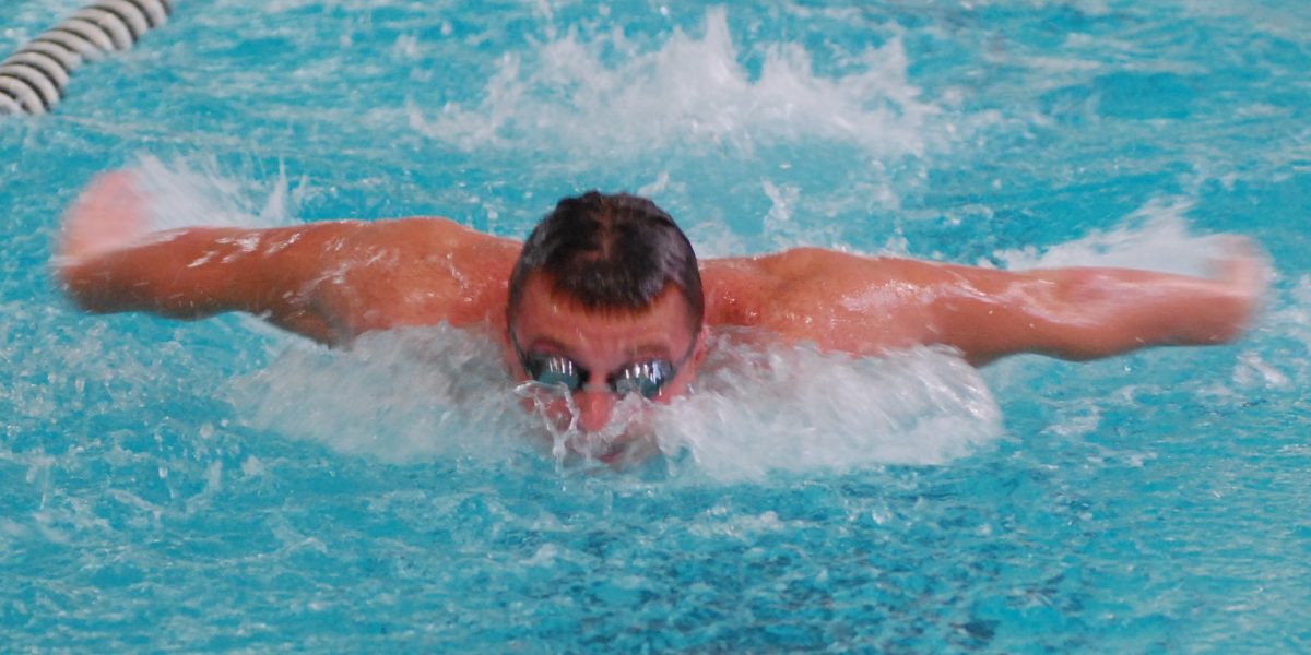 Senior Zach Rogers swims at a meet early on in the season.