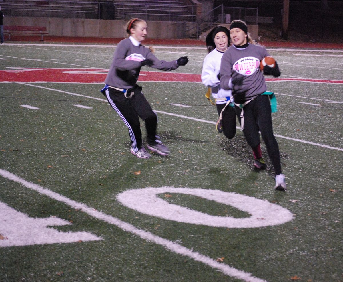 Senior Jessica Brady blocks junior Rebecca Poscover from getting the football from Bain, who was running back for the senior team. Photo courtesy of the PCH Corral. 