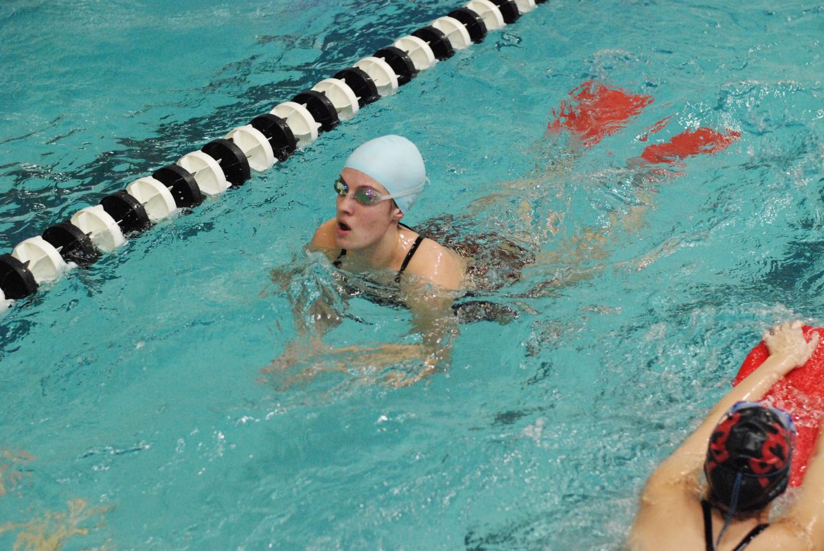 Senior+Katie+Rembold+practices+with+fins+on+Dec.+9.+She+switched+from+basketball+to+swimming+her+senior+year.+Photo+by+Matthew+Walter.