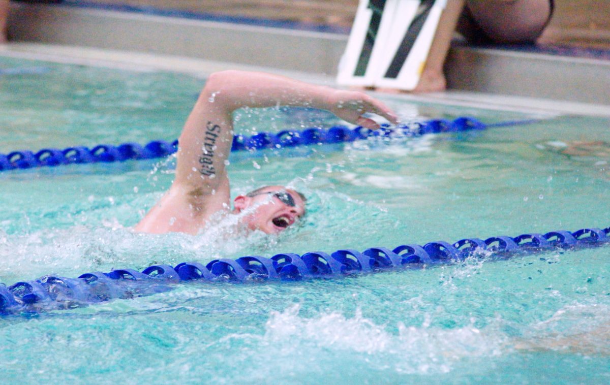 Senior+Zach+Rogers+finishes+the+last+quarter+of+his+500-yard+freestyle+on+Oct.+17+at+home+against+Clayton.+Photos+by+Elizabeth+Leath.