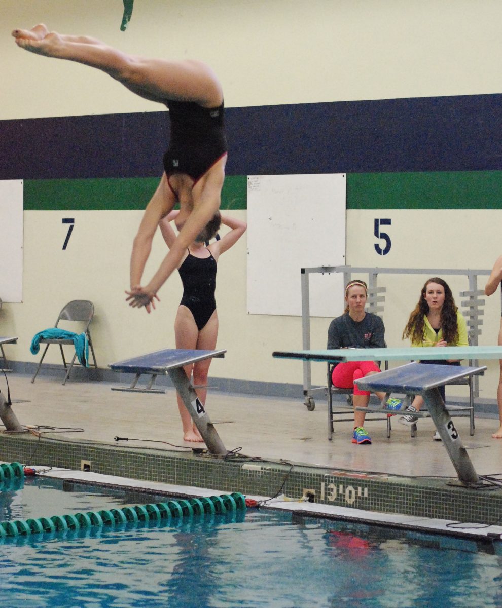 Senior Hannah Swyers is in the midst of an inward dive pike at Marquette on Jan. 30. Photo by Elizabeth Leath. 