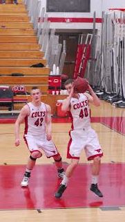 Senior Nathan Biggs (left) and senior Connor Kraus look to push the ball in transition against University City on February 22.  Biggs eclipsed the 1000 point mark for his high school career March 7.  Photo by Emily Schenberg.