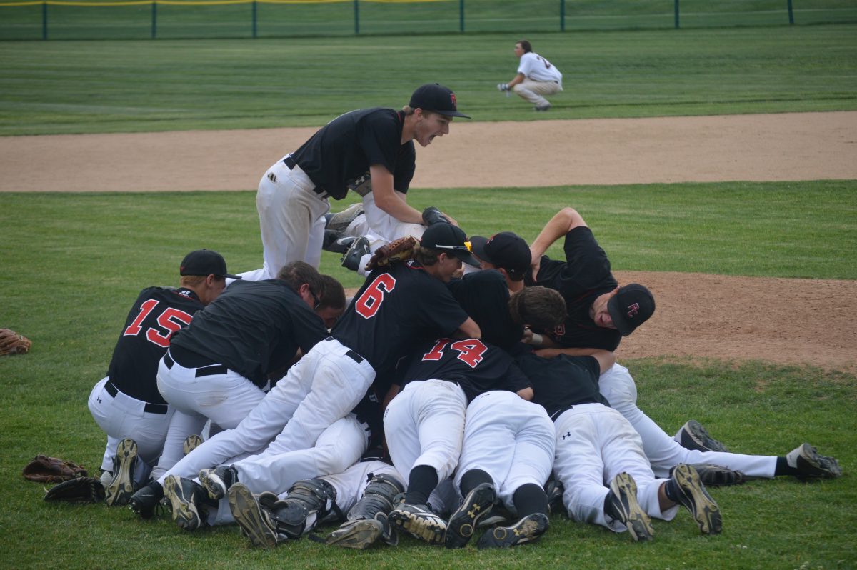 Sophomore Josh Konecek leaps on top of the dog pile immediately after the Colts won the championship. Photo by Jeffrey Eidelman.