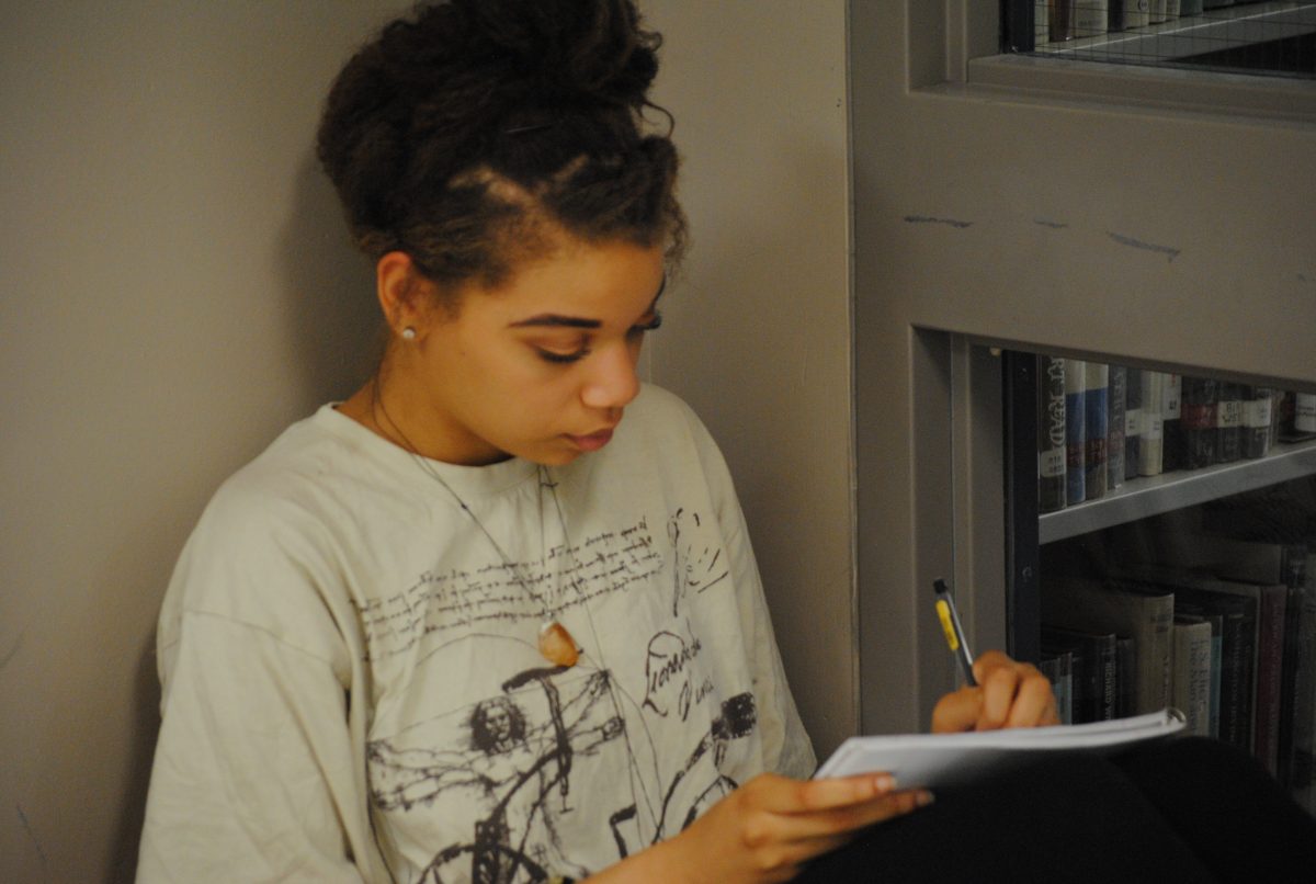 Ashley Wright (12) begins writing in her notebook some ideas for her creative writing class. Photo by Jeffrey Eidelman