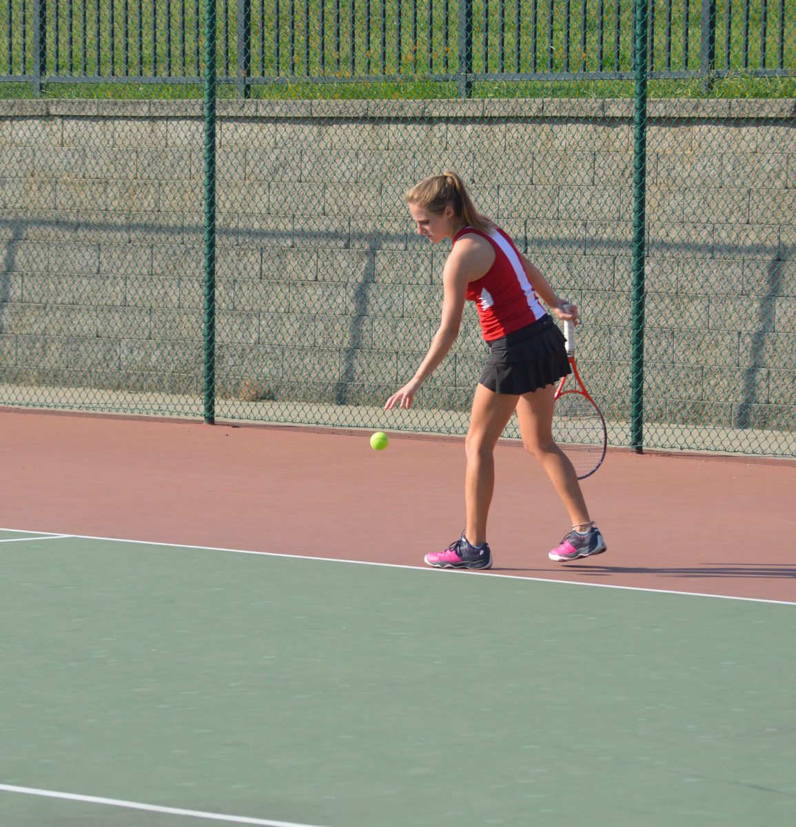 Sophomore Elena Wilner prepares to serve at a match on September 30, 2014.