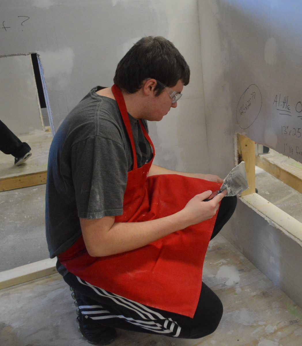 Senior Nathan Mellenbruch inspects his work in construction tech, taught by Todd Pannett. Photo by Zoe Raft. 