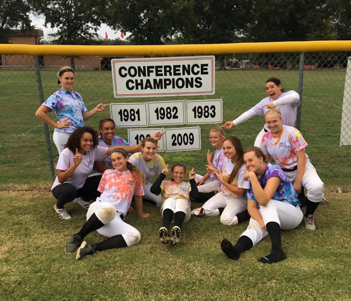 The+members+of+the+softball+team+celebrate+after+winning+the+2016+Conference+Championship+Sept.+29+on+their+home+field.+Photo+courtesy+of+Emily+West
