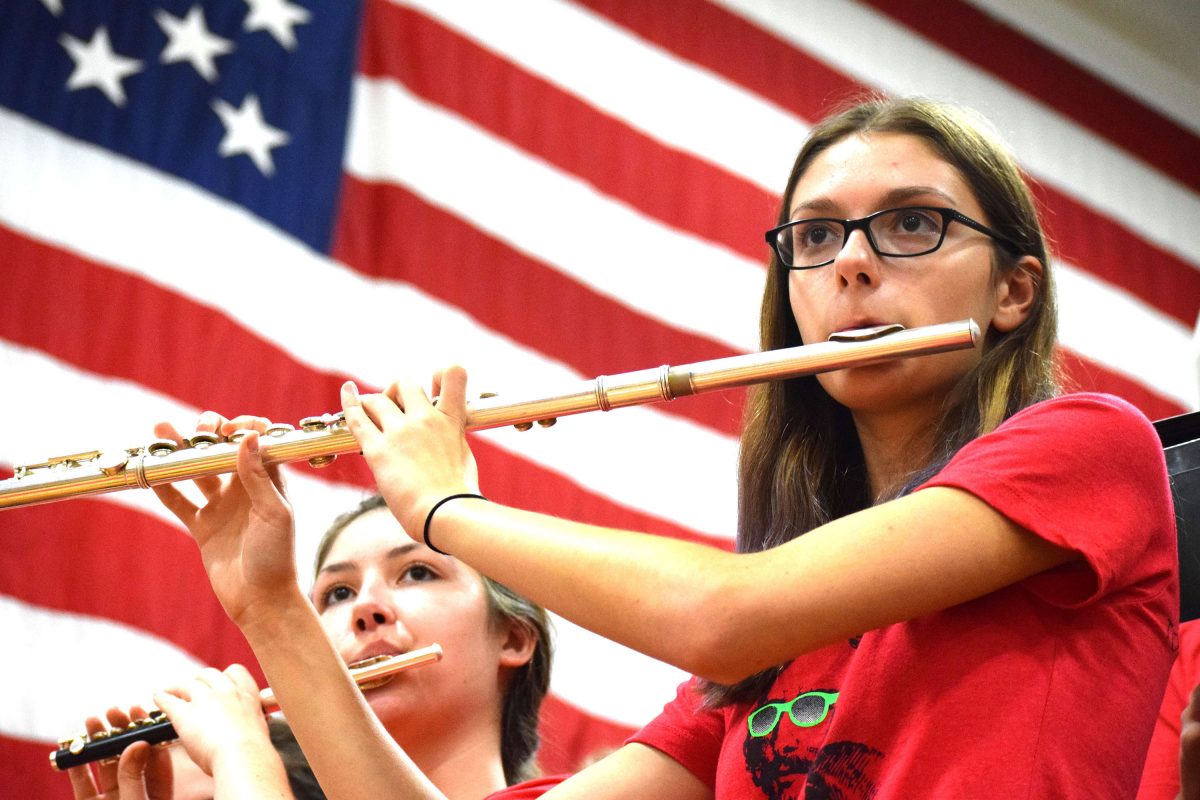 Juniors Stella Bauer and Hannah Kornblum perform the national anthem at the start of the Homecoming pep assembly on Friday, Sept. 9.