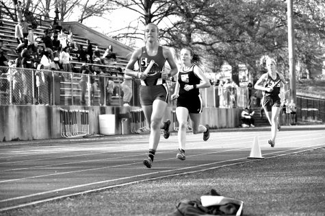 Senior Richelle Bain finishes her leg of the varsity 4x800-meter relay
at the Henle Holmes meet at home on April 12. Photo by Madeline
Lee