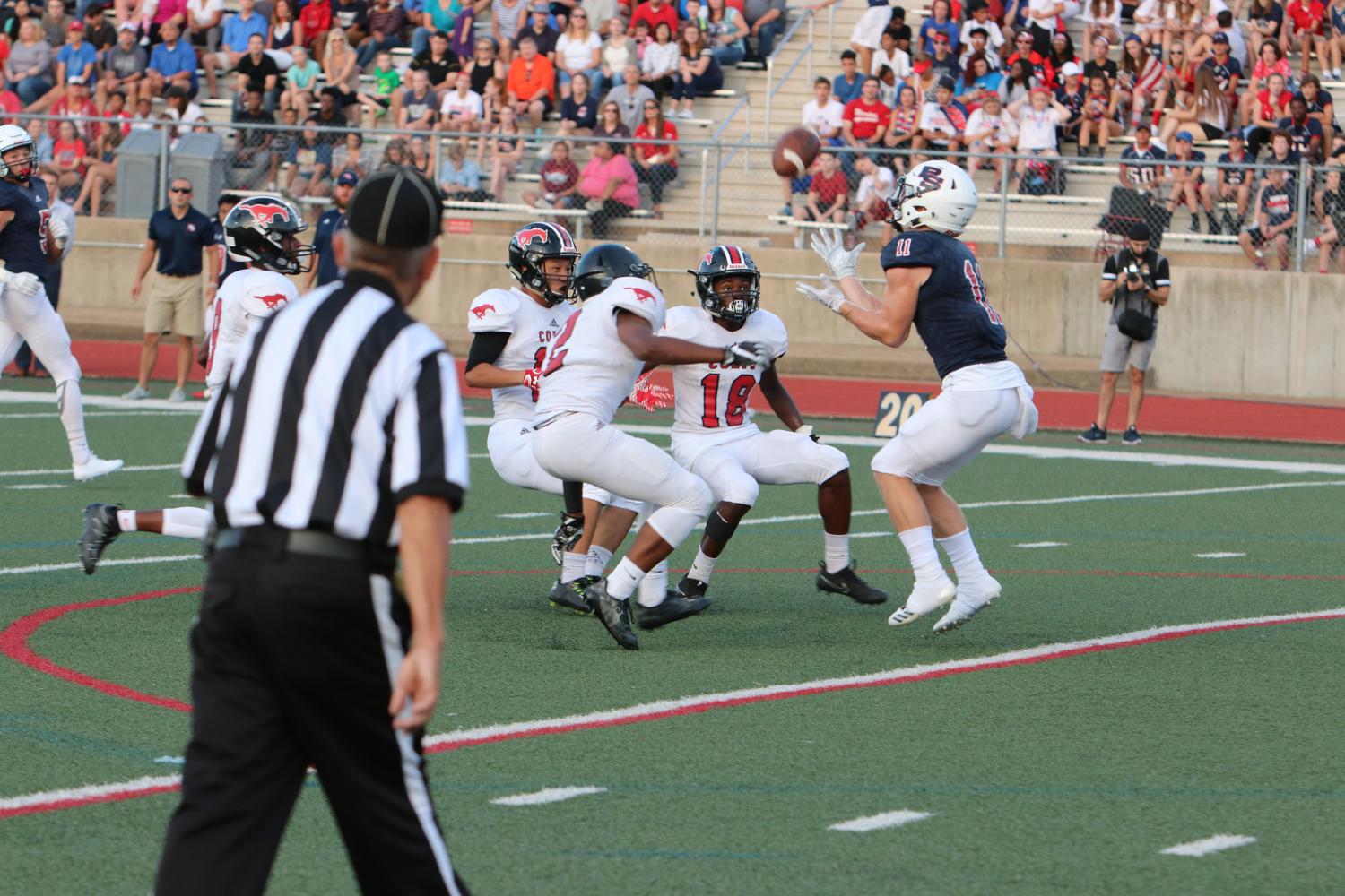 Senior Nate Moore (18) breaks down with Sophomore teammate Antonio Hutti (2) and fellow Senior Andy Chen (12) to tackle the Parkway South punt returner.