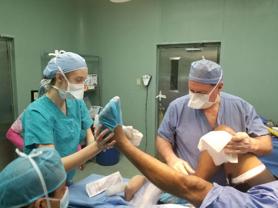 Sheridan assists in a knee surgery during her mission trip. She enjoyed shadowing and working behind the scenes. Photo courtesy of Tom Stamos.