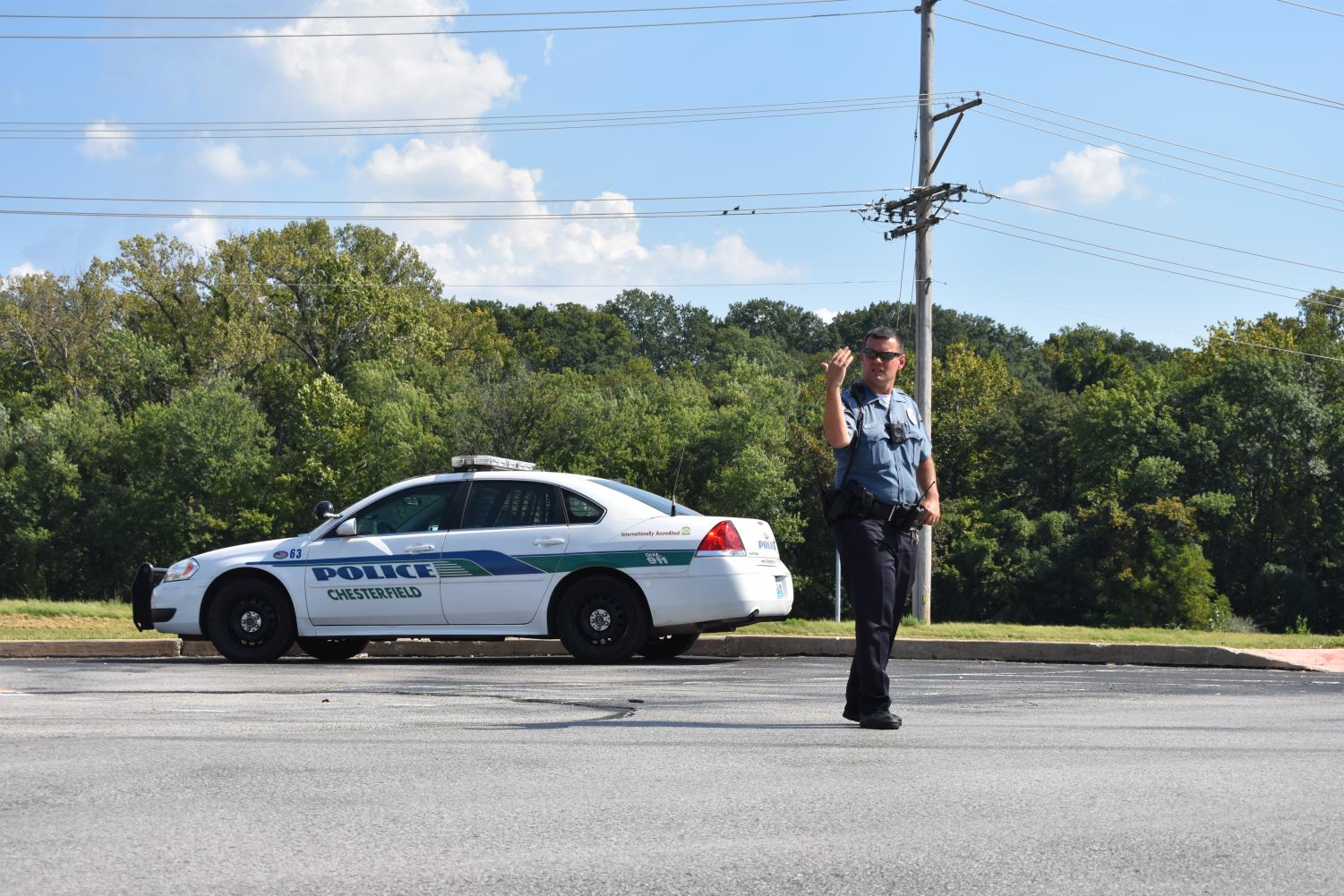 New School Resource Officer Travis Layton directs after-school traffic. This is on of the many duties an SRO will perform.