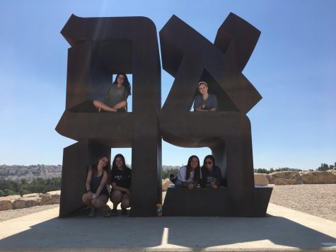 Junior Brette Gershenson and friends sitting on a statue at the Israeli art museum. Photo courtesy of Brette Gershenson.