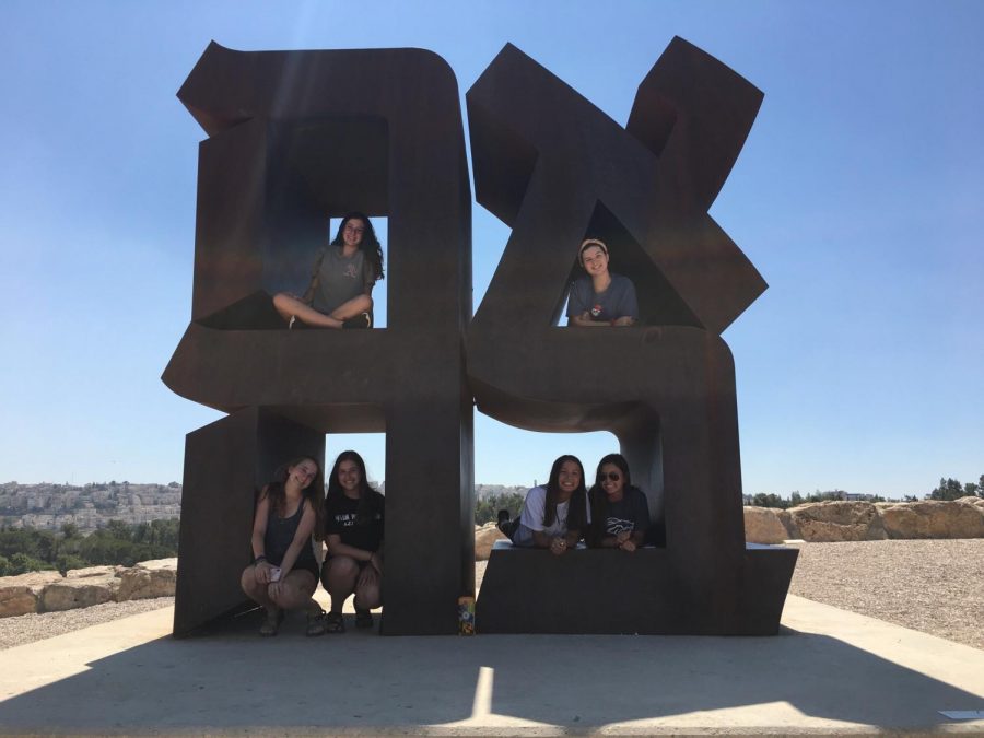 Junior Brette Gershenson and friends sitting on a statue at the Israeli art museum. Photo courtesy of Brette Gershenson. 