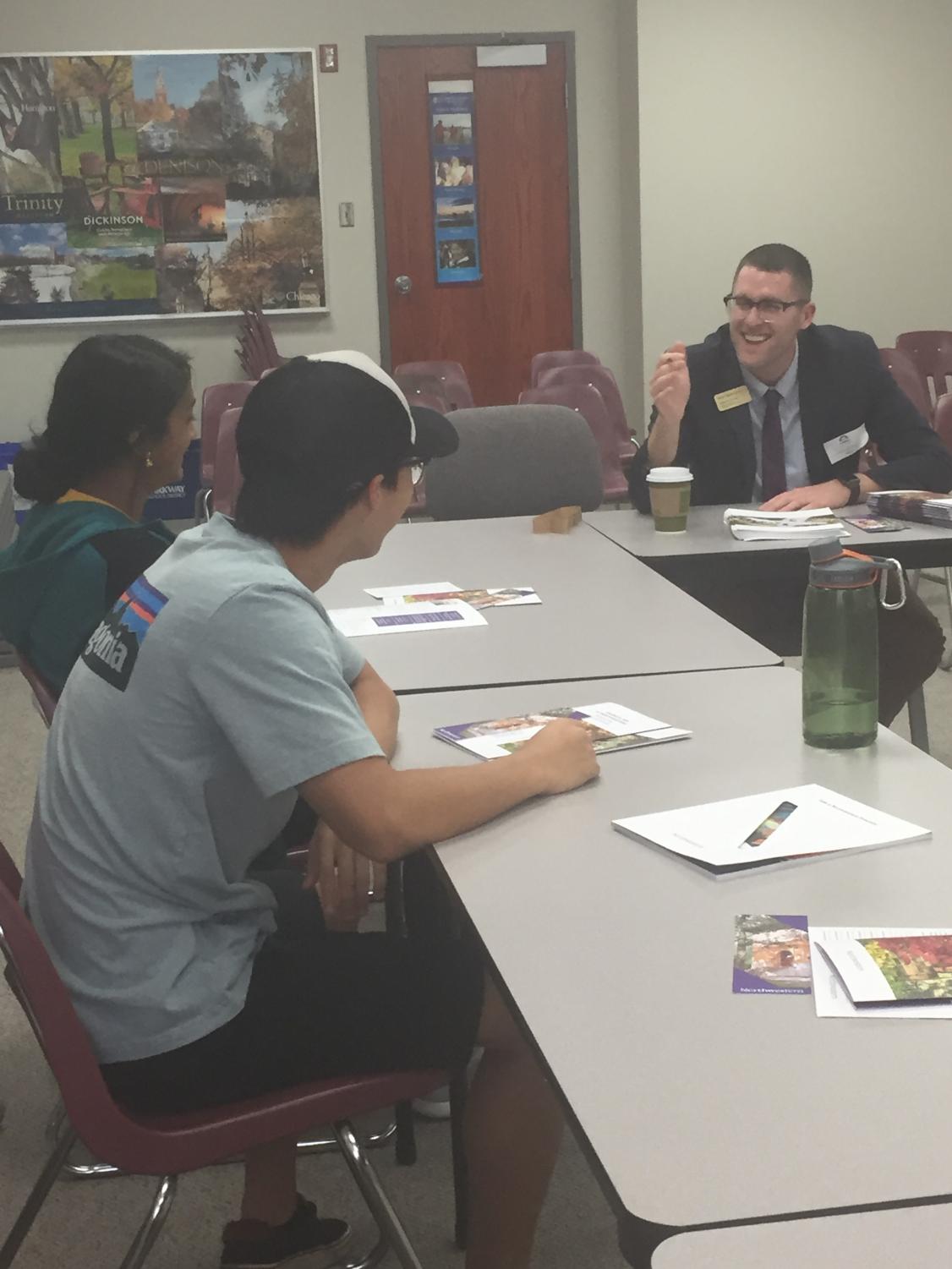 Seniors Divya Minnaganti and Preston Chen meet with Northwestern college admissions officer in the counseling office on Sept. 22. Photo by Shoshana Weinstein.
