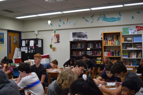 Freshmen Taylor Murray, Daniel Baris, Xavier Leguet work in Kemba Metropoulos’ English 1 Class.