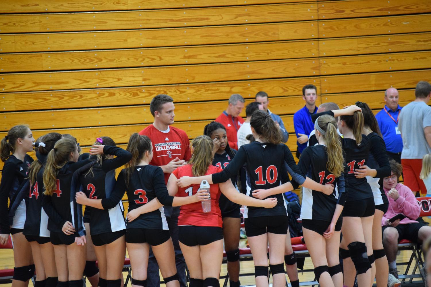 Assistant Coach Nathan Biggs talks to his team prior to the second set against Westminster.