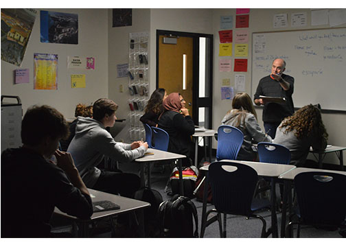 Spanish teacher Daniel Kelty talks with students of his Spanish 3 class on what they would do in the case of various natural disasters such as floods and tornadoes on Oct. 26. The communicative approach deals more with real life application of the language, having students answer and ask questions using their language.