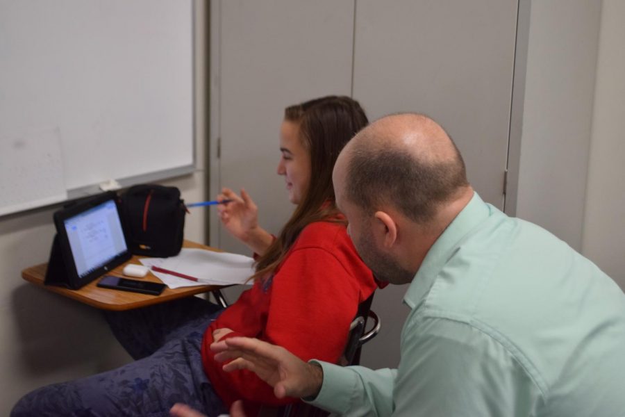 Algebra teacher Ricky Halteman helps Natalie Williams (9) in sixth hour Algebra lab. Photo taken by Gabby Abowitz.