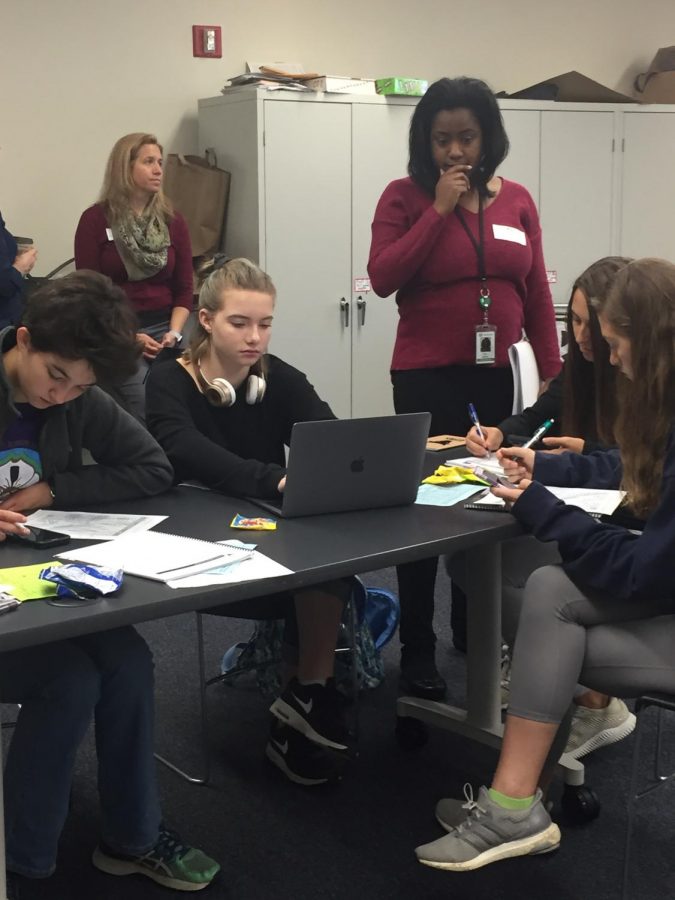 From left to right: Kylie Jost (10), Alexis Schnatmeier (10), Julie Ryterski  (10), and Talia Emch (12) meet with a representative of TD Ameritrade during AC Lab on Oct. 17. Photo by Shoshana Weinstein.