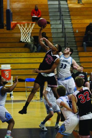 Junior center Devion Harris goes up for a shot against St.Charles West on Dec. 7. The Colts won the game 51-38.