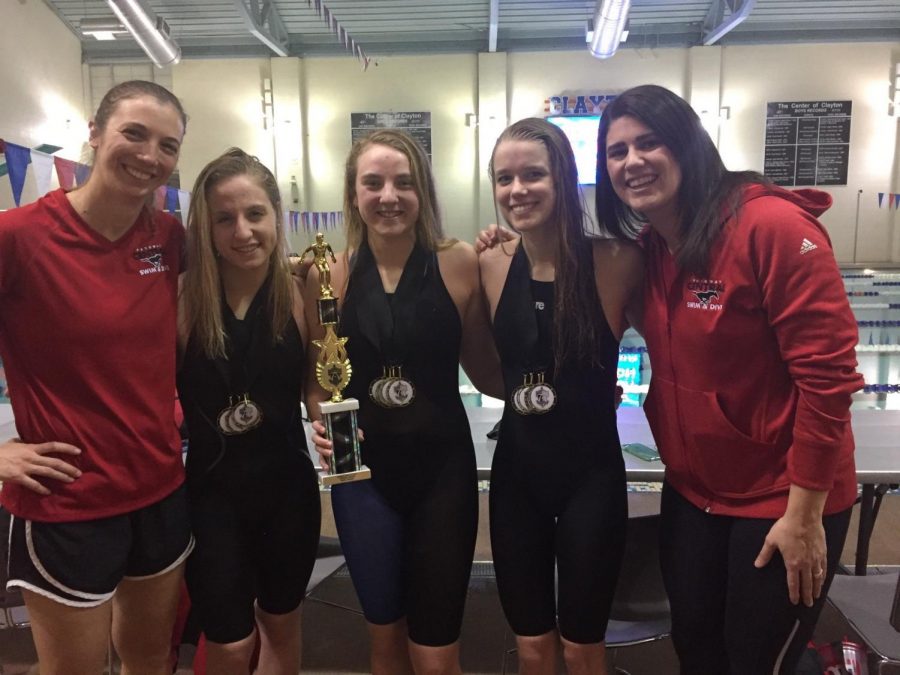 Former Head Coach Meyer and current Head Coach Seidel pose with former Parkway Central swimmers, Madison, Alexis Poe, and Annika Hofer. Photo courtesy of Jennifer Meyer