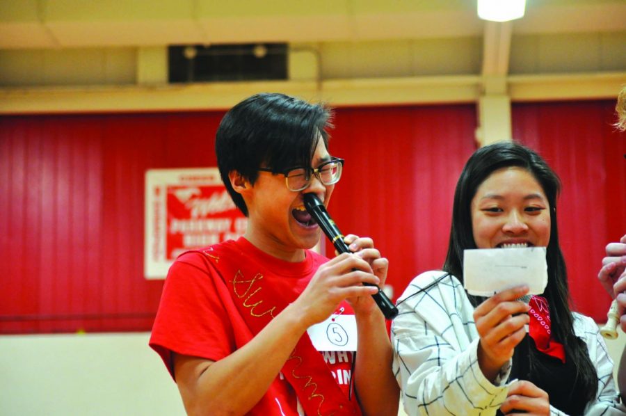 Left to right: Preston Chen plays the recorder with is nose while Tiffany Huang holds up notes. 
