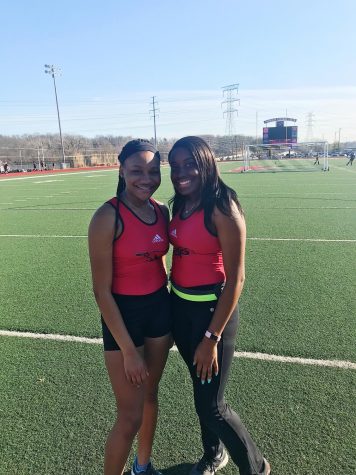 Freshman Nnenna Okpara, and senior Ogechi Okpara posing on the track in their track uniforms on Monday, 3/11. Photo courtesy of Nnenna Okpara.