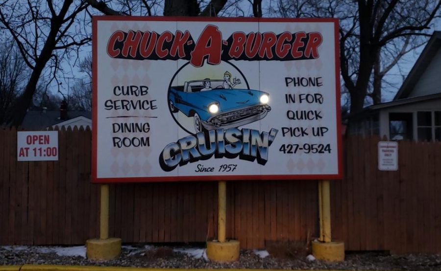 The restaurant sign for Chuck-A-Burger, with actual lit bulbs for the cars headlights.